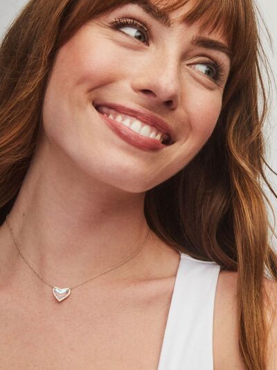 A beautiful heart pendant necklace made of copper and 14K gold-plated, showcasing its elegant design and craftsmanship.