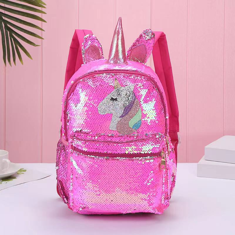 Colorful unicorn backpack with sequins, adjustable straps, and side pockets, made from recycled materials.