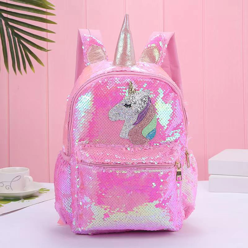 Colorful unicorn backpack with sequins, adjustable straps, and side pockets, made from recycled materials.