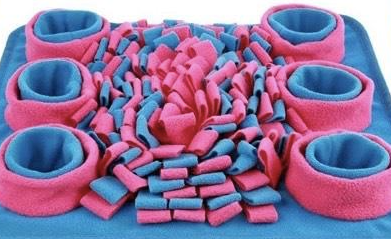 A colorful Snuffle Mat for pets featuring various textures and bowls for hiding treats, designed to stimulate pets' minds and encourage slow feeding.