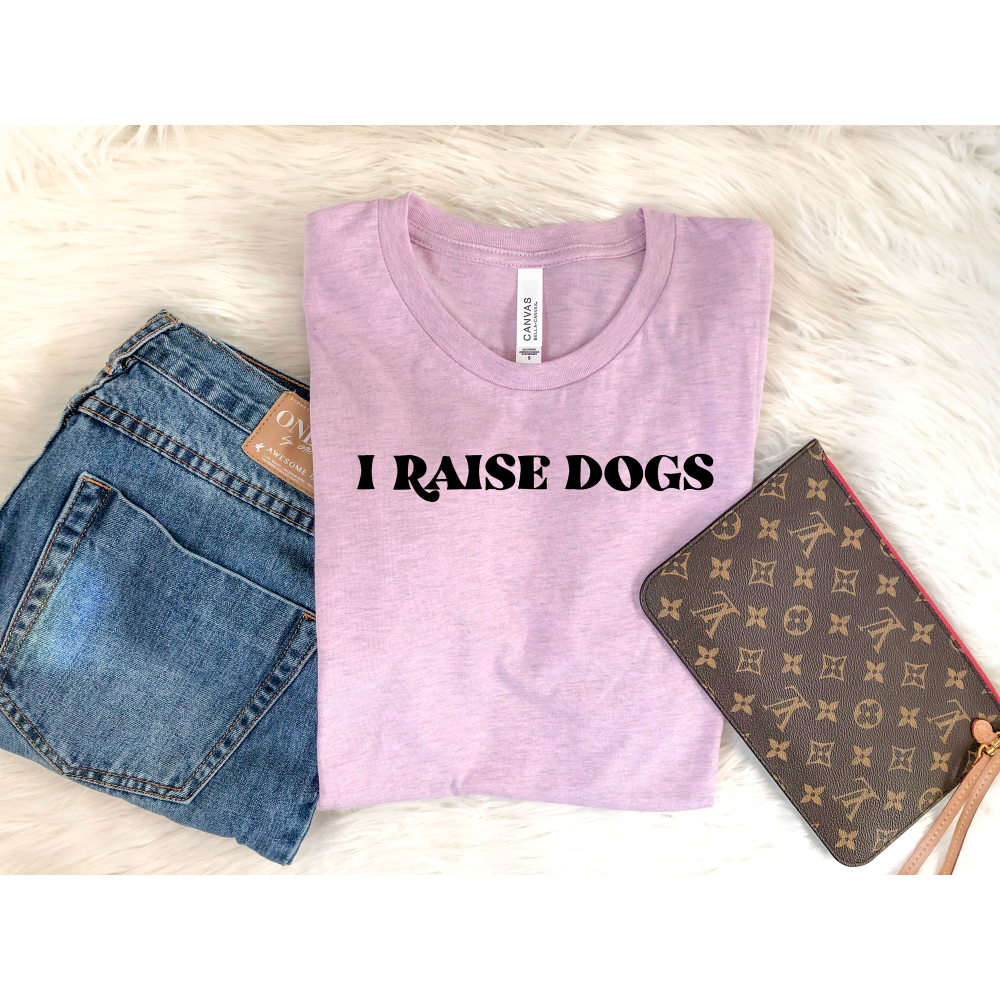 A soft crew neck tee with the text 'I Raise Dogs' printed in vibrant colors, perfect for dog lovers.