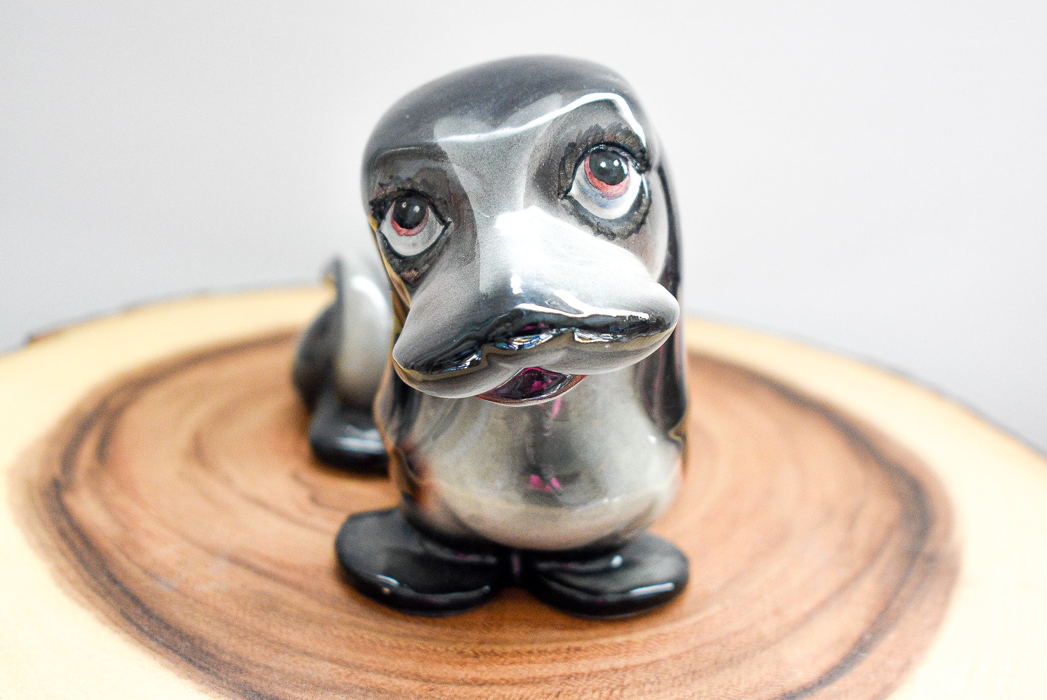 Vintage J. W. Co. Dachshund figurine made of porcelain, approximately 5 inches tall, showcasing intricate details and craftsmanship.