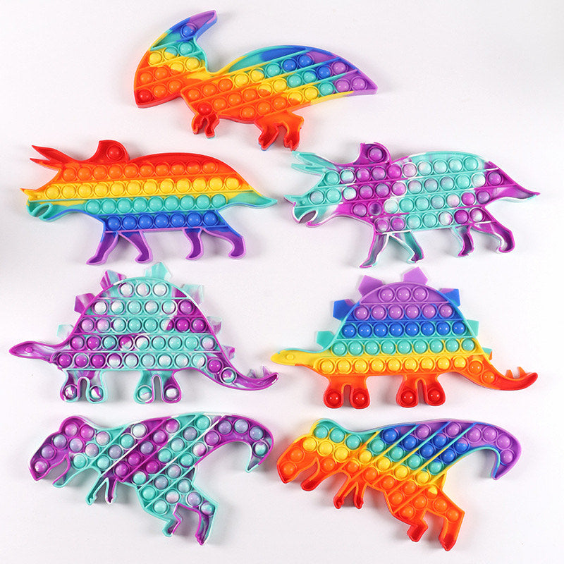 A colorful Jumbo Push Pop Fidget Toy shaped like dinosaurs, made from durable silicone, showcasing its popping bubbles.
