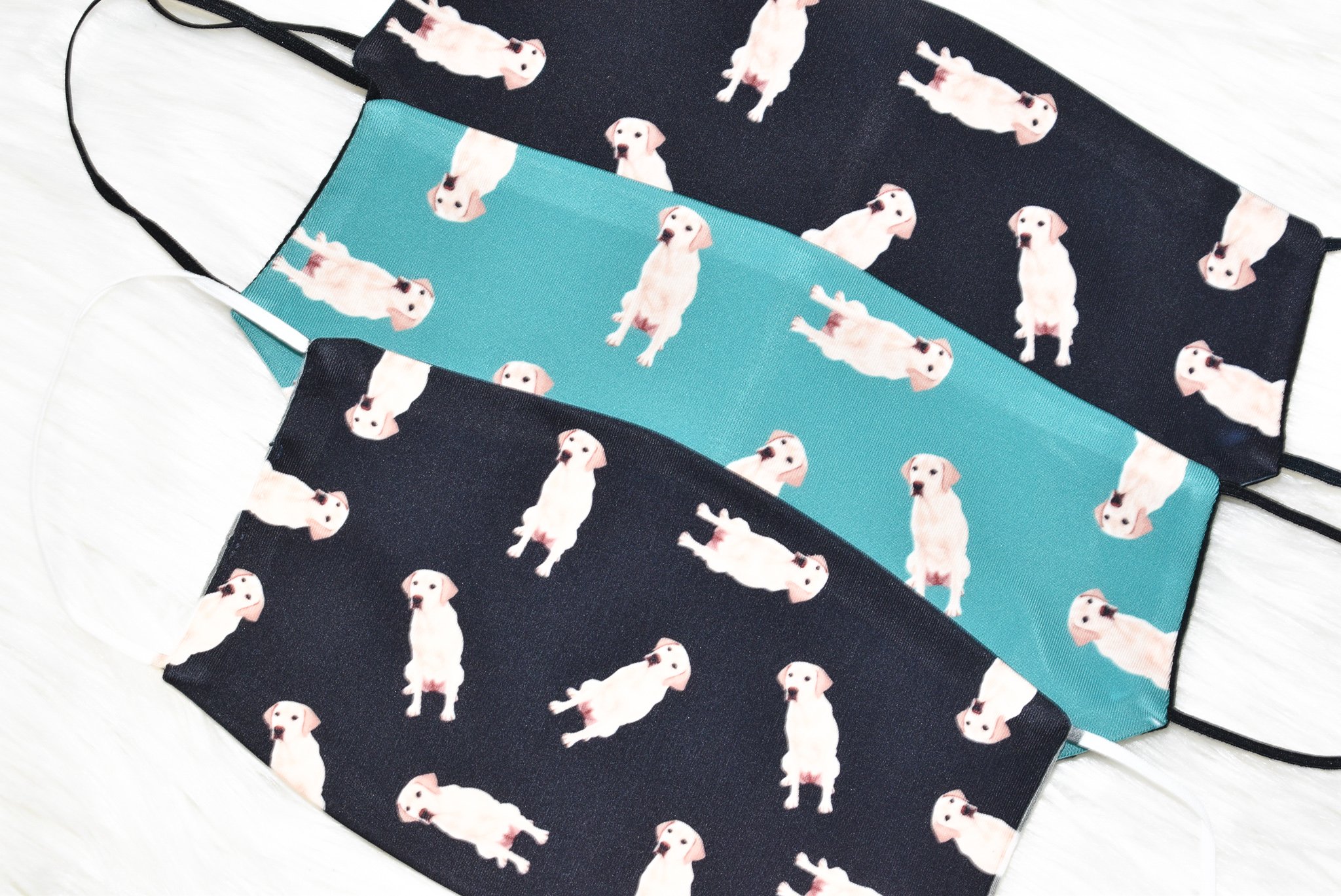 A handmade Labrador Retriever face cover featuring a soft organic cotton interior and durable polyester exterior, available in various sizes.