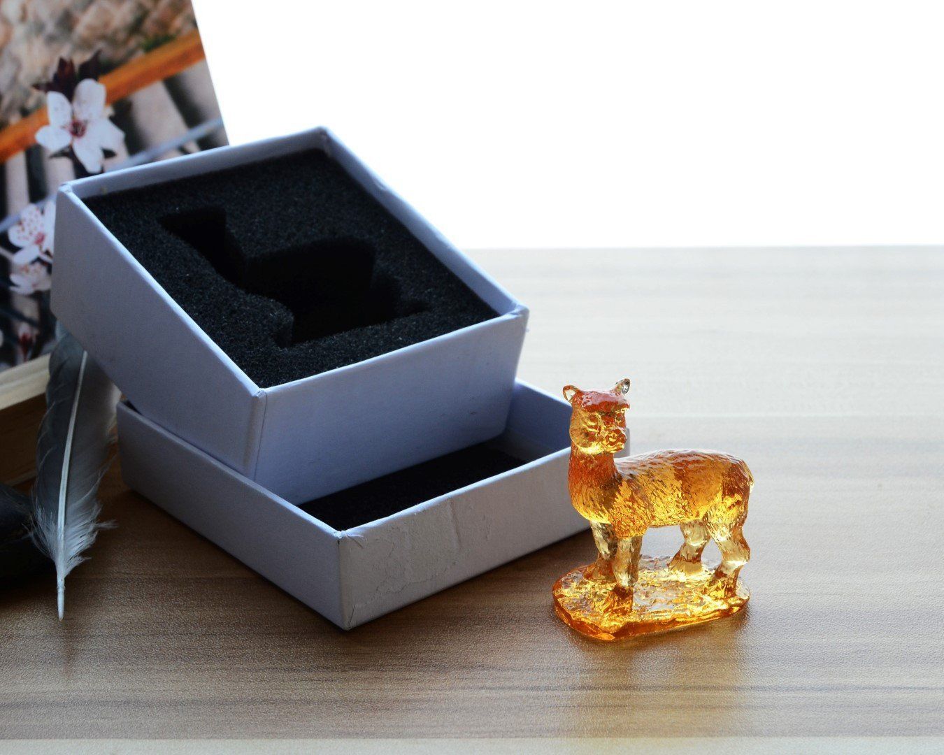 A beautifully crafted Liuli Crystal Alpaca Figurine showcasing intricate details and vibrant colors, perfect for home decor.