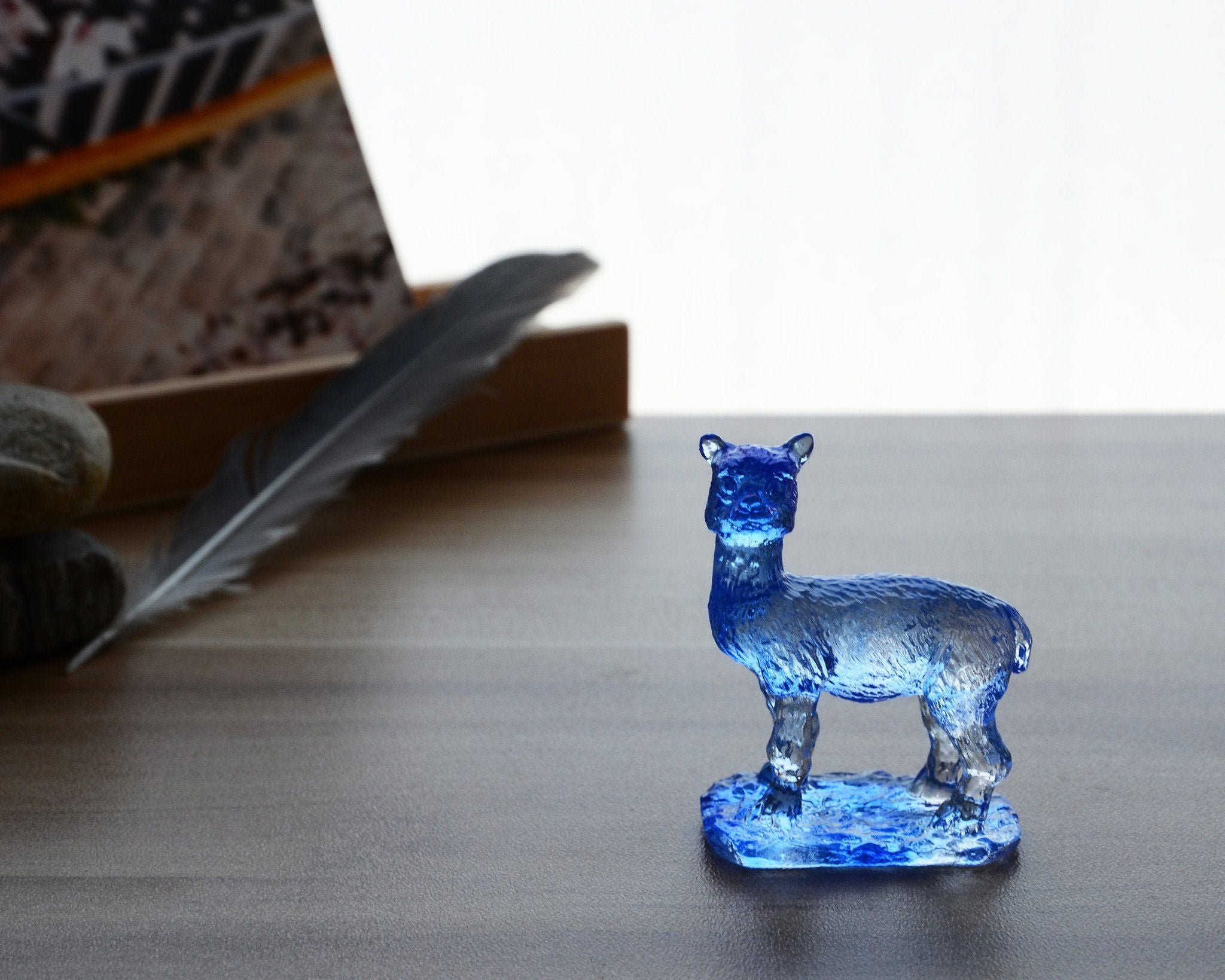 A beautifully crafted Liuli Crystal Alpaca Figurine showcasing intricate details and vibrant colors, perfect for home decor.