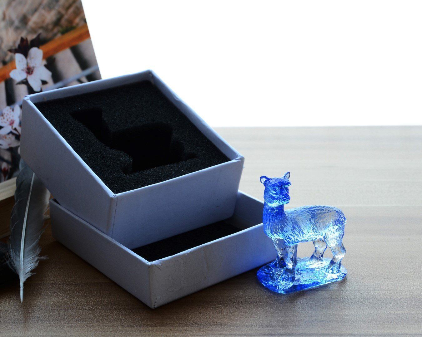 A beautifully crafted Liuli Crystal Alpaca Figurine showcasing intricate details and vibrant colors, perfect for home decor.