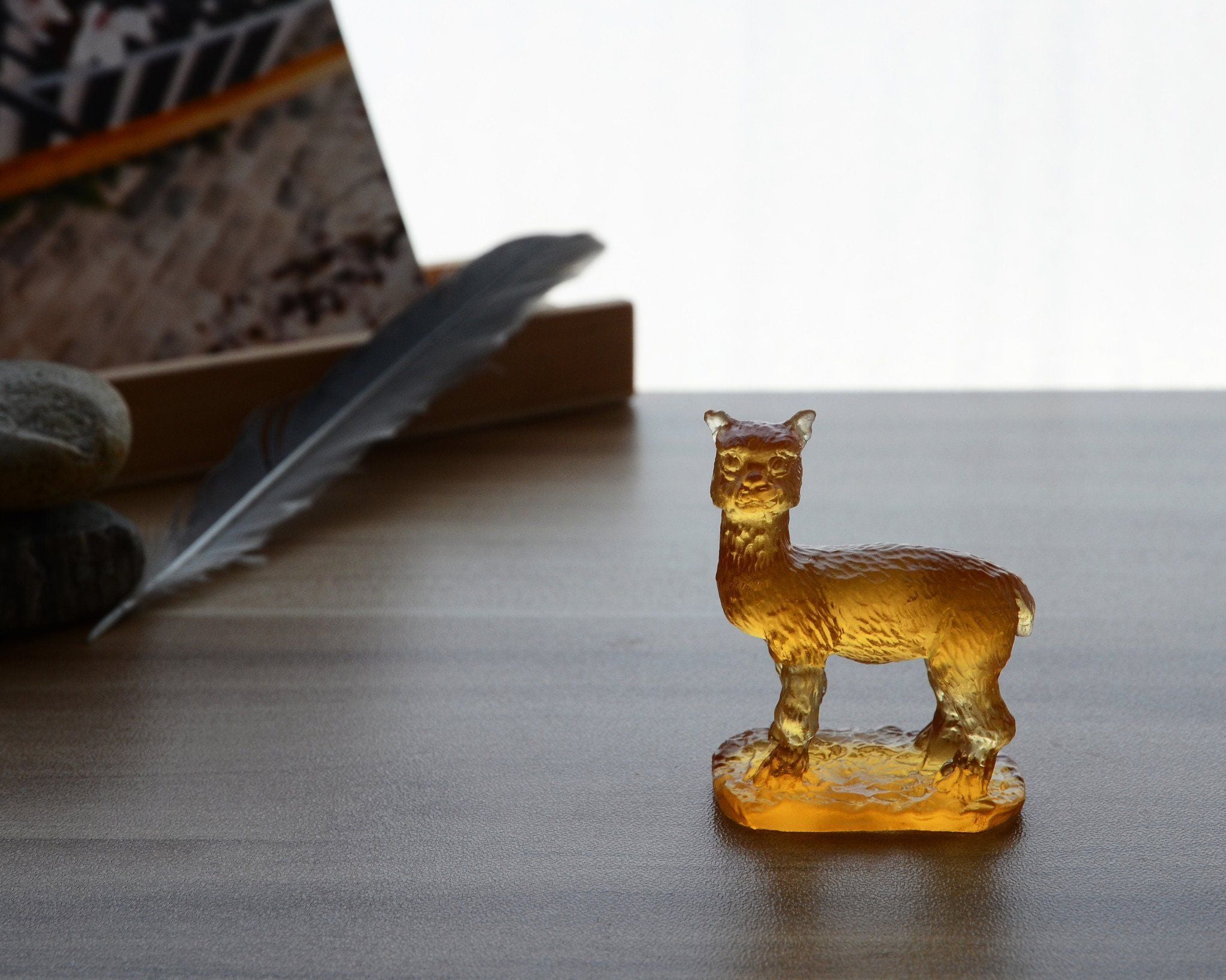 A beautifully crafted Liuli Crystal Alpaca Figurine showcasing intricate details and vibrant colors, perfect for home decor.