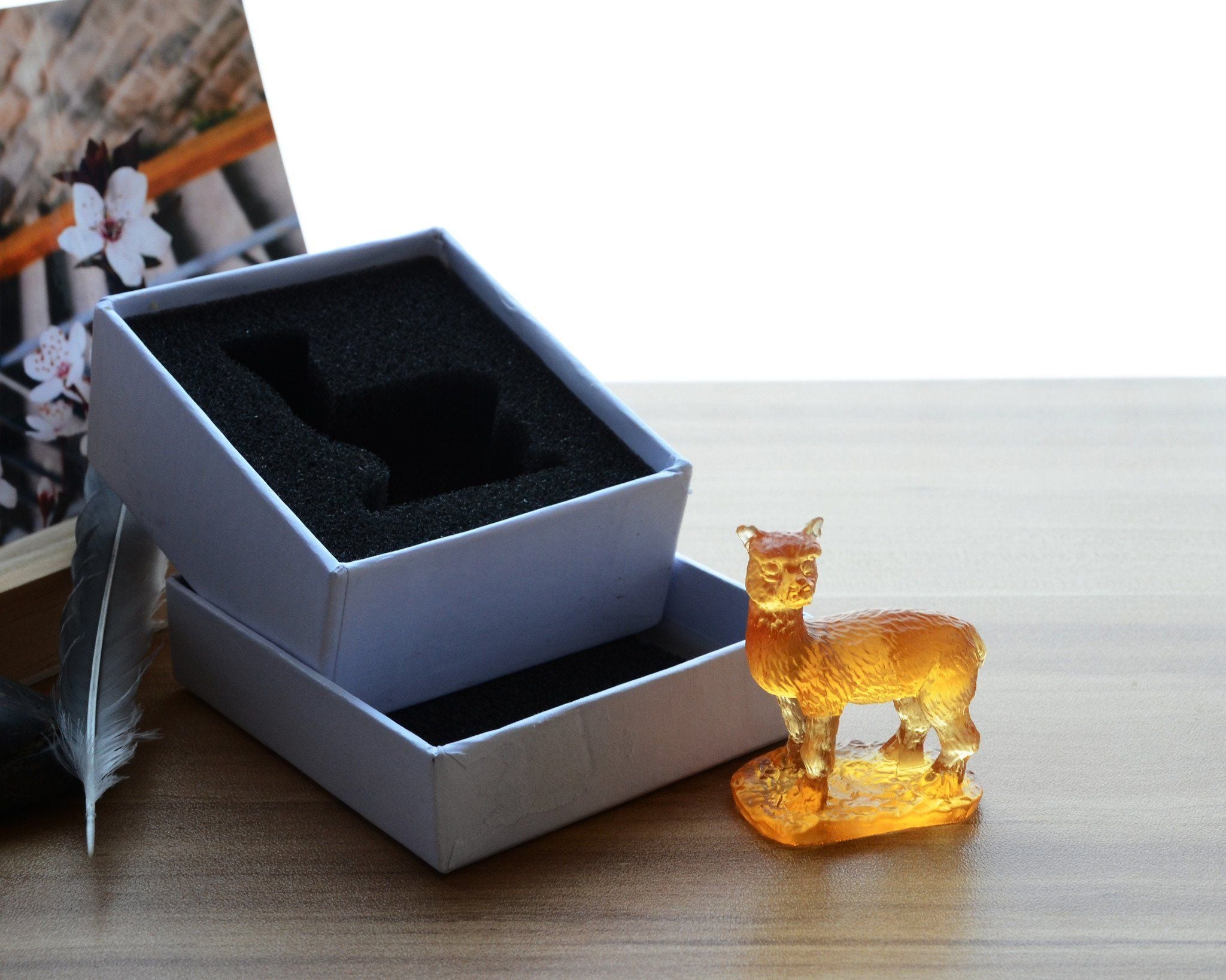 A beautifully crafted Liuli Crystal Alpaca Figurine showcasing intricate details and vibrant colors, perfect for home decor.