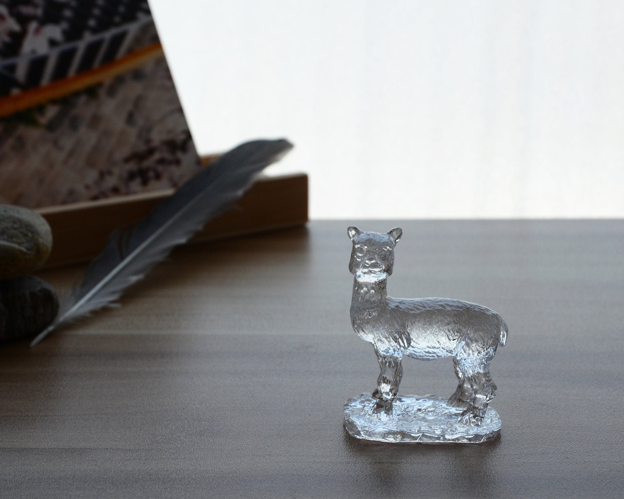 A beautifully crafted Liuli Crystal Alpaca Figurine showcasing intricate details and vibrant colors, perfect for home decor.