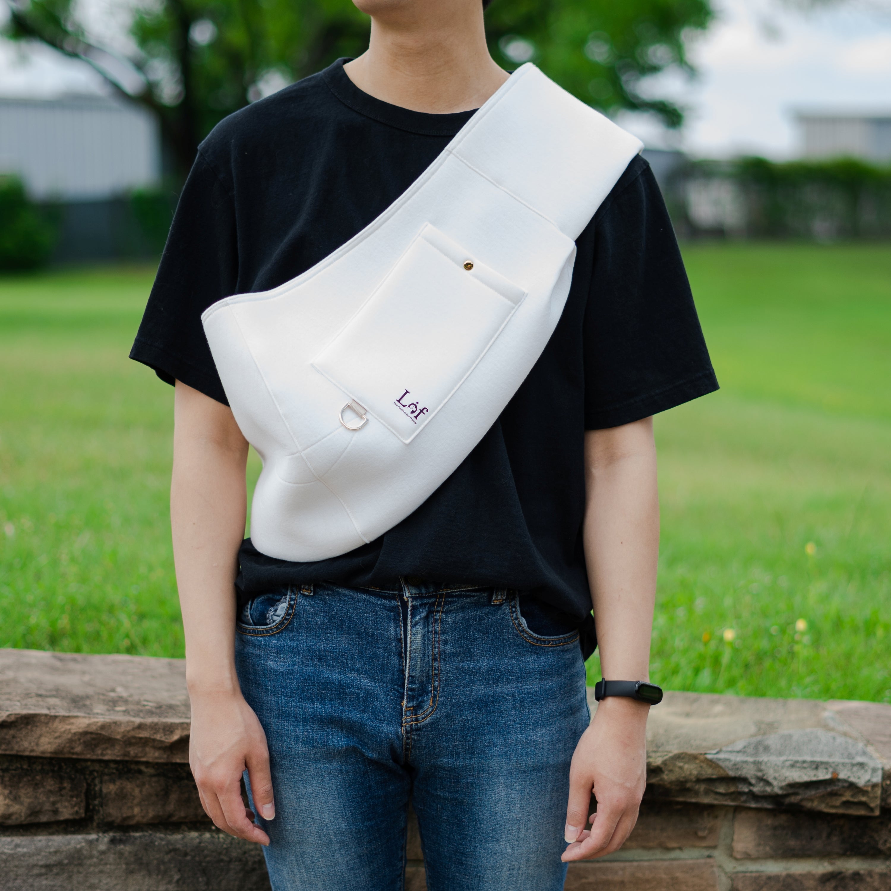 Lof Neoprene Pet Sling Carrier in stylish design, securely holding a small dog, showcasing its comfort and convenience.