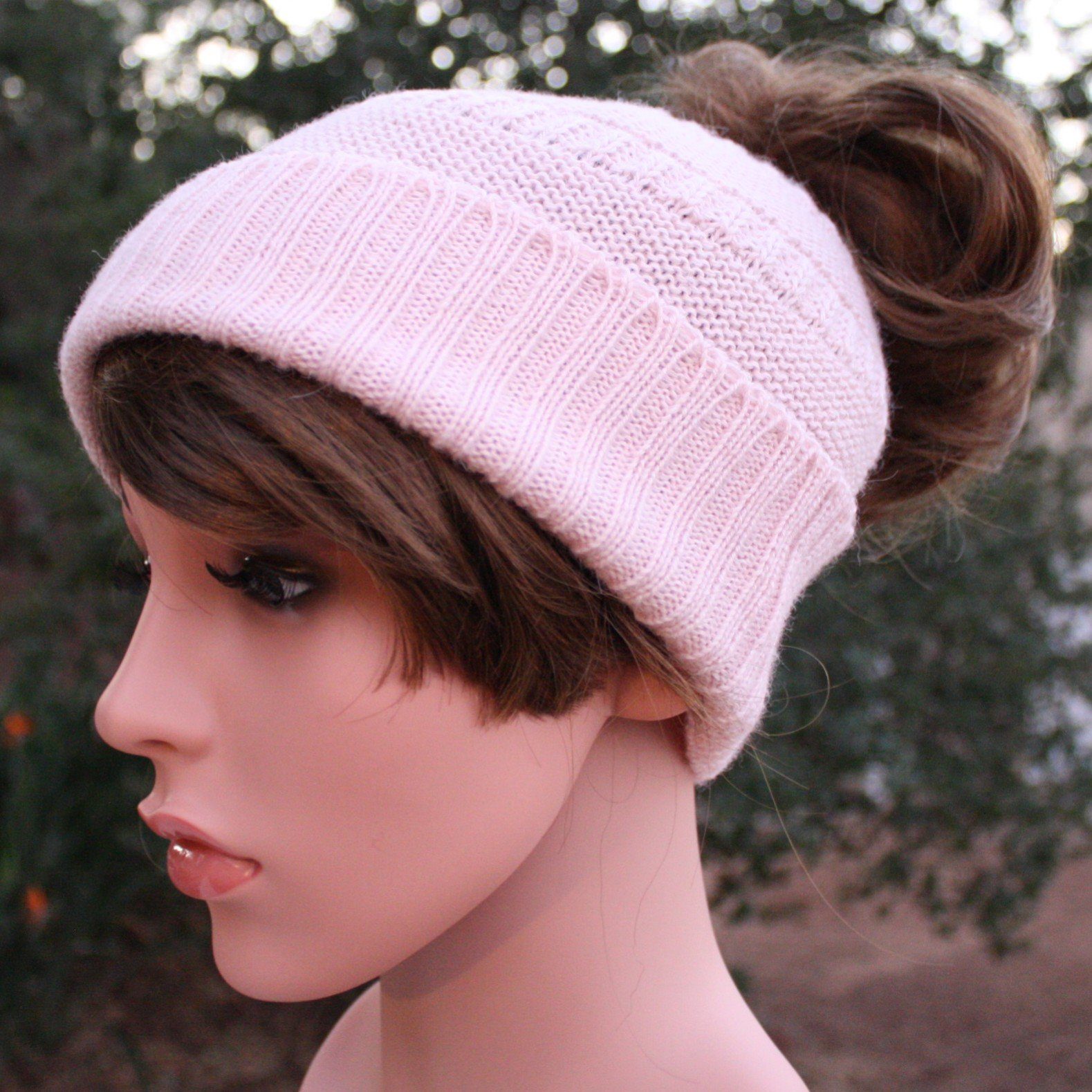 A cozy Messy Bun Alpaca Hat showcasing a stylish design with a ponytail hole, made from a soft alpaca blend, perfect for cool weather.