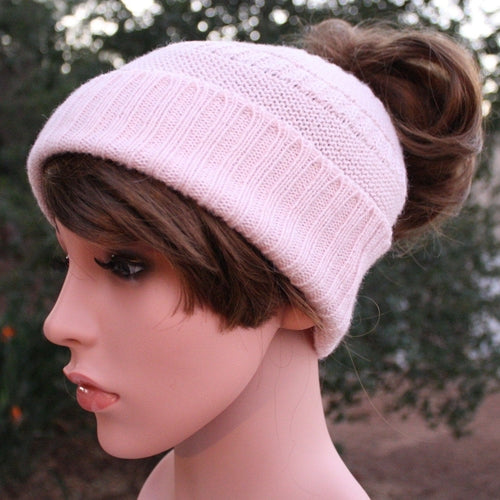 A cozy Messy Bun Alpaca Hat showcasing a stylish design with a ponytail hole, made from a soft alpaca blend, perfect for cool weather.