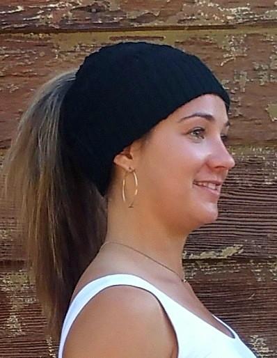 A cozy Messy Bun Alpaca Hat showcasing a stylish design with a ponytail hole, made from a soft alpaca blend, perfect for cool weather.