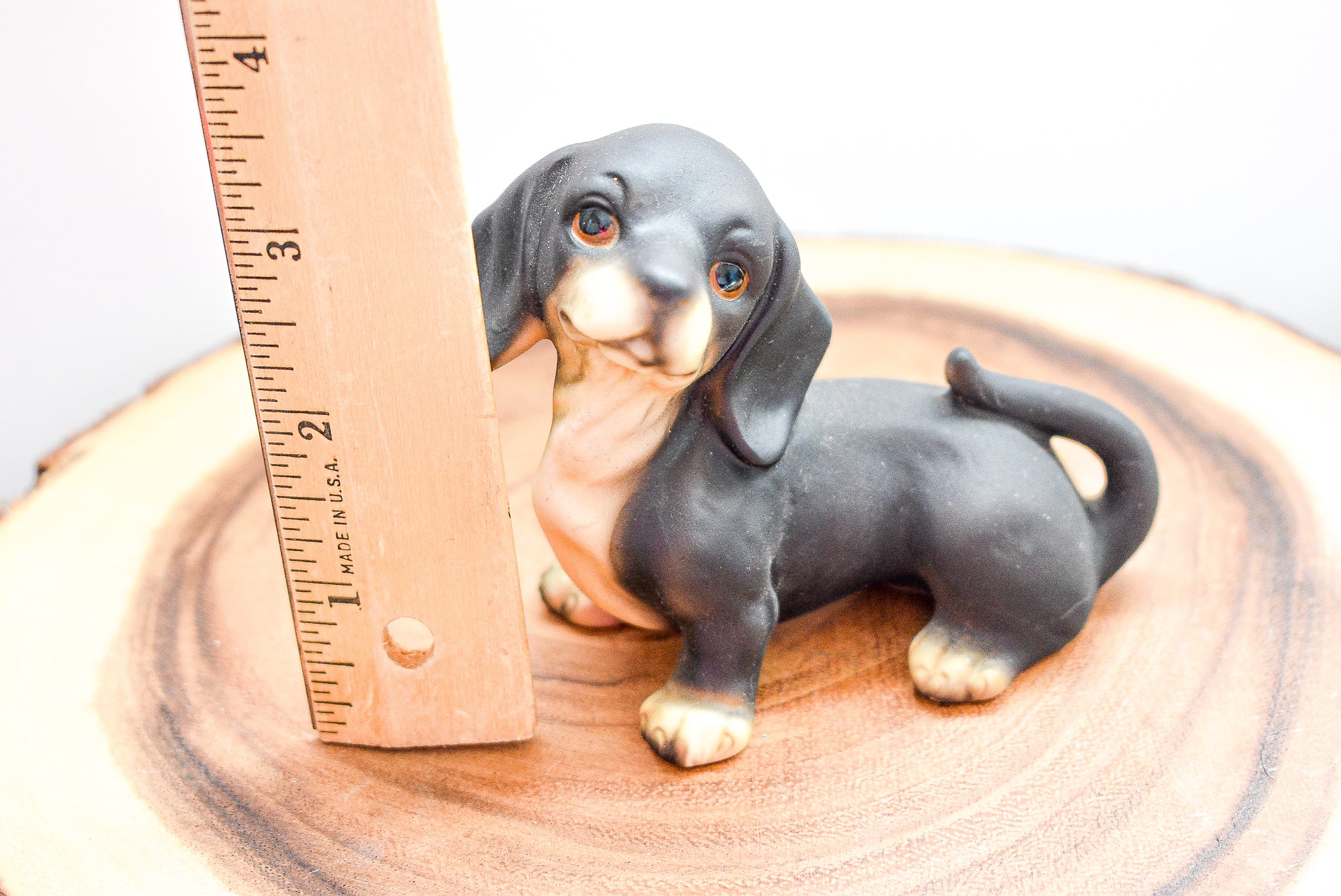 A detailed MSR Imports Dachshund figurine made of porcelain, showcasing intricate craftsmanship and a charming design.
