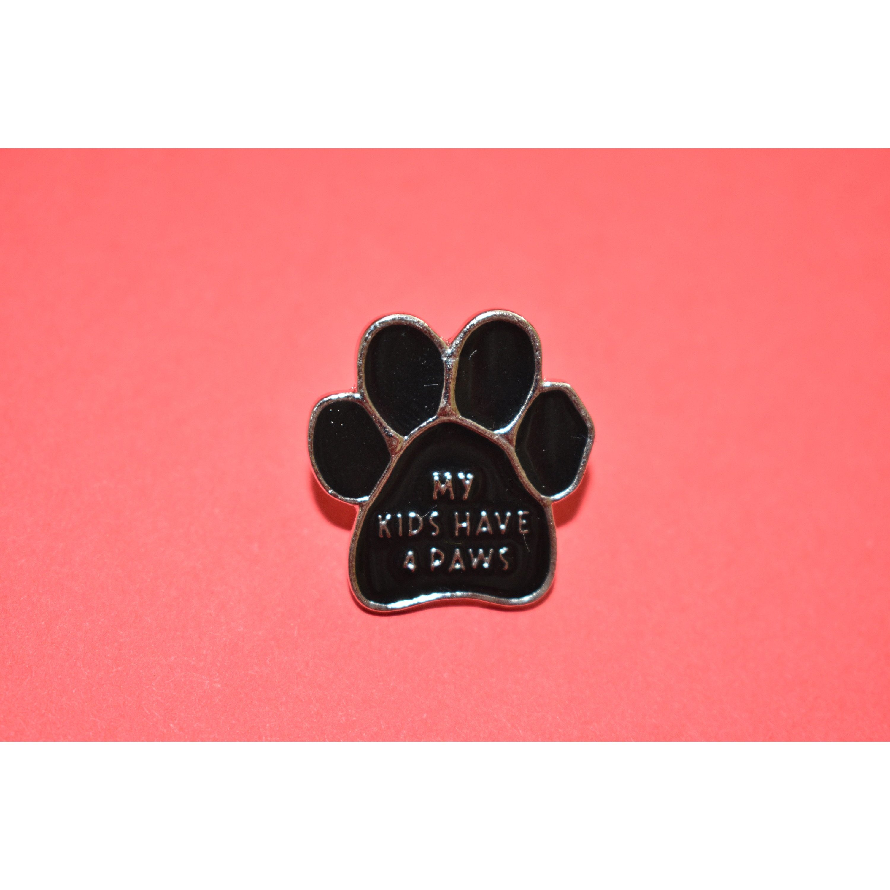 My Kids Have 4 Paws Enamel Pin featuring a cute dog-themed design, secured with a metal clasp, perfect for dog lovers.