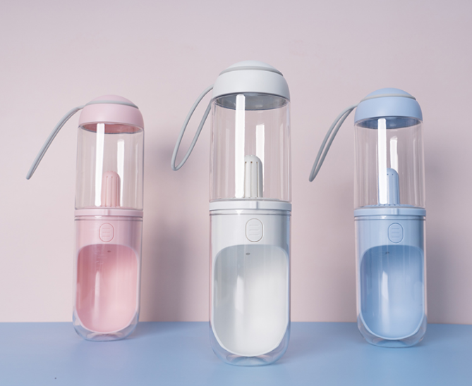 Outdoor Travel Pet Water Dispenser for dogs and cats, featuring a U-shaped trough and a silicone strap for easy carrying.