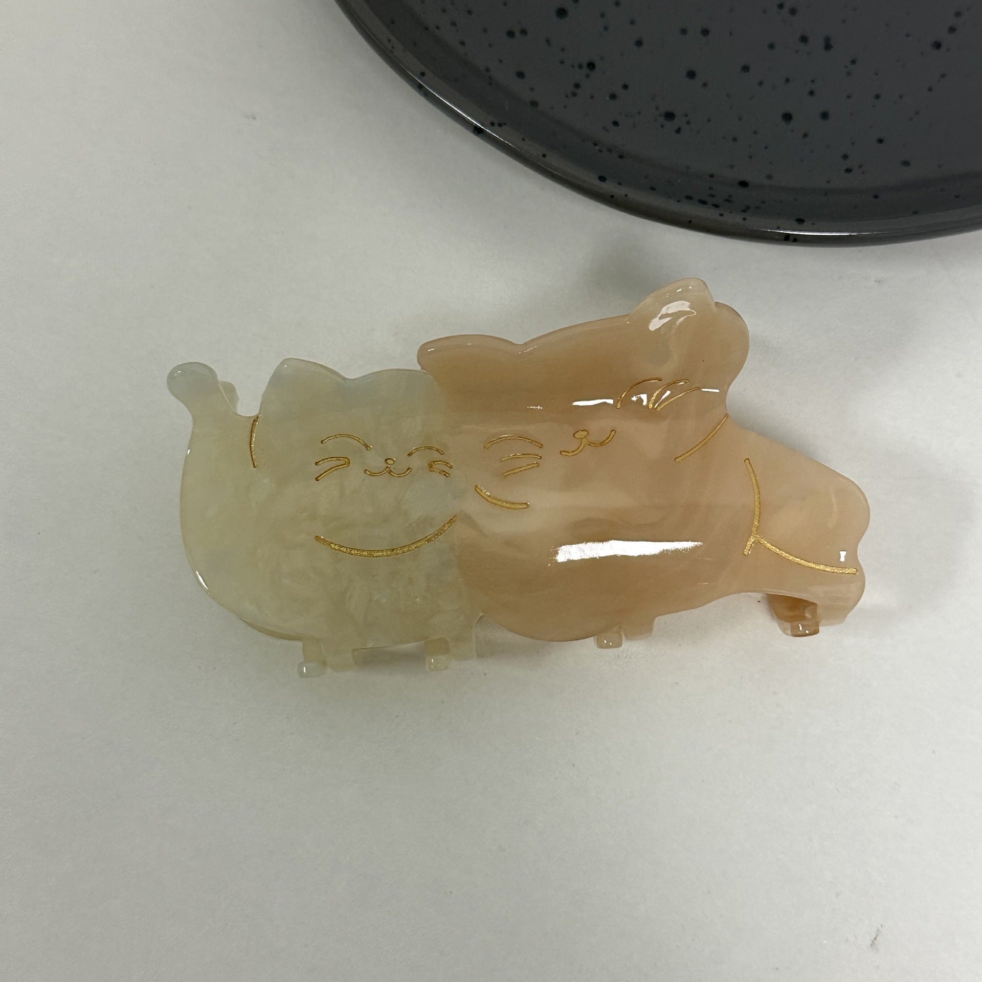 Hand-painted claw hair clip featuring a pug design, made from eco-friendly cellulose acetate, showcasing a unique and stylish accessory for pet lovers.