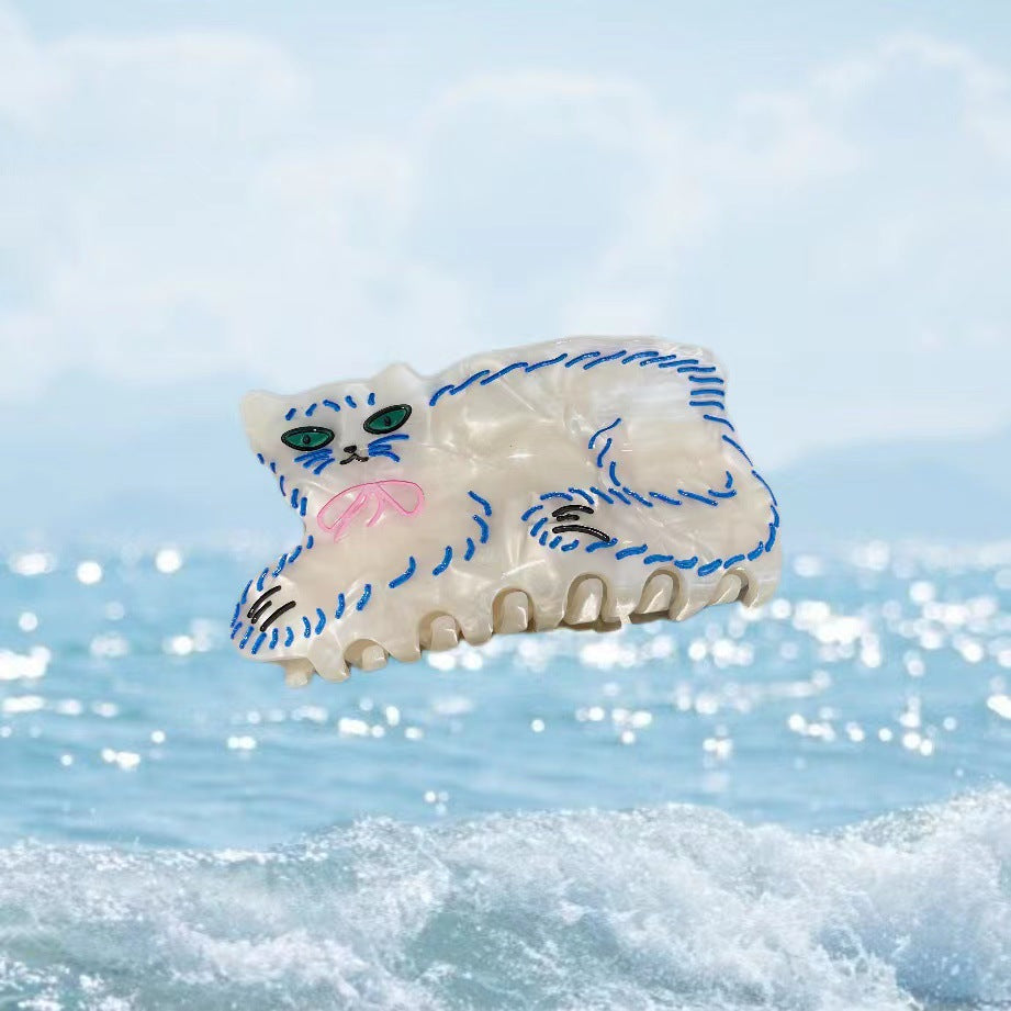 Hand-painted claw hair clip featuring a pug design, made from eco-friendly cellulose acetate.