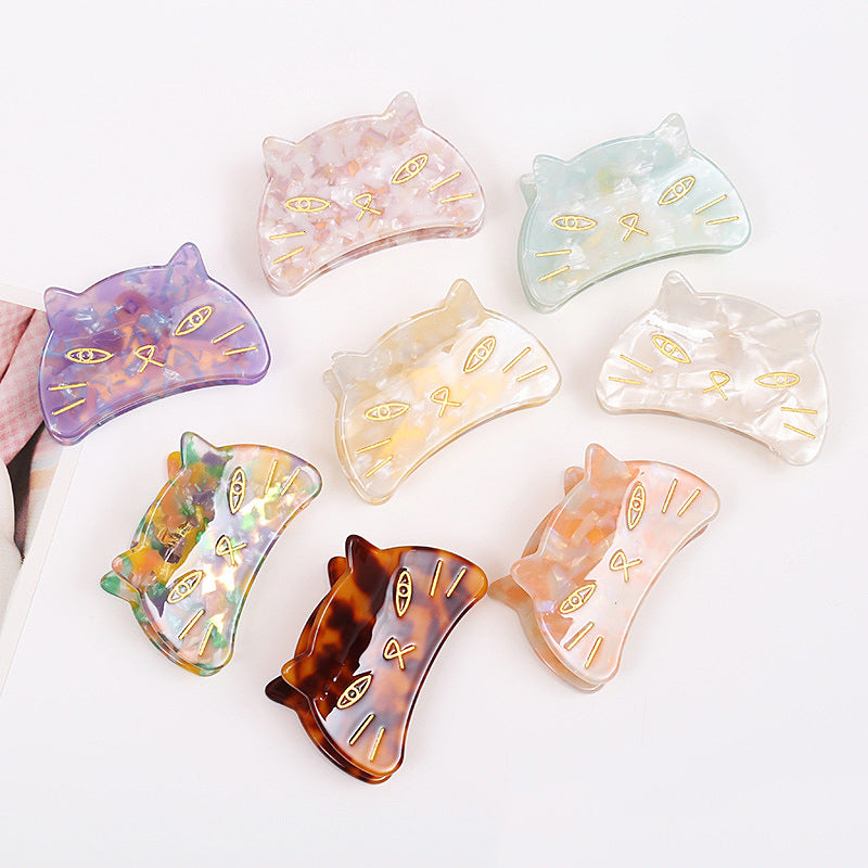 Hand-painted cat head claw hair clip by Pawsome Pets New York, showcasing vibrant colors and intricate details.