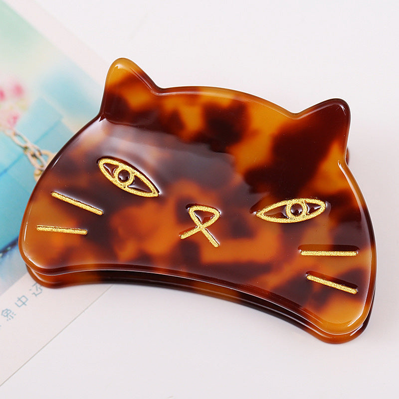 Hand-painted cat head claw hair clip by Pawsome Pets New York, showcasing vibrant colors and intricate details.