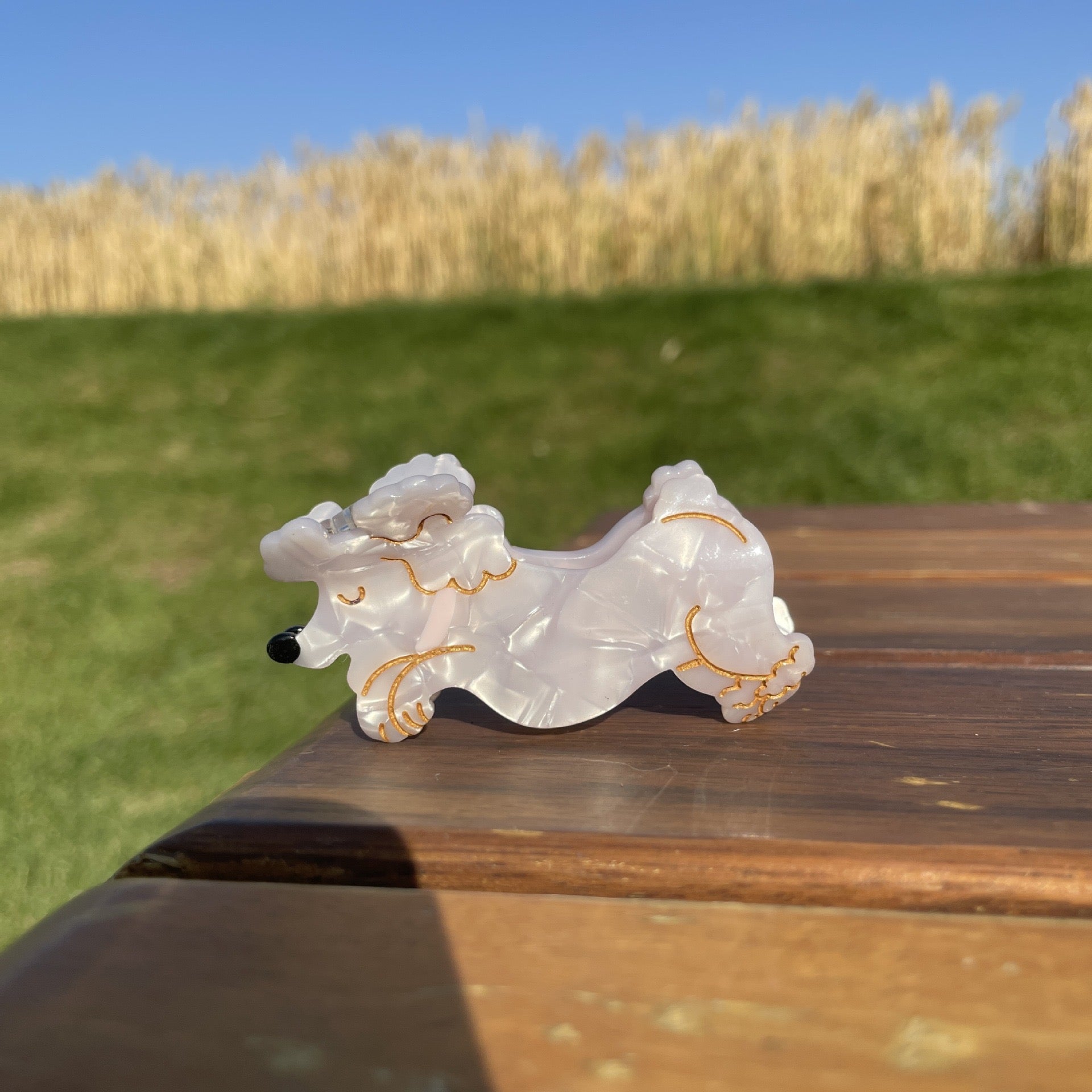 Hand-painted claw hair clip featuring a Pug design, crafted from eco-friendly cellulose acetate, showcasing a unique and stylish accessory for dog lovers.