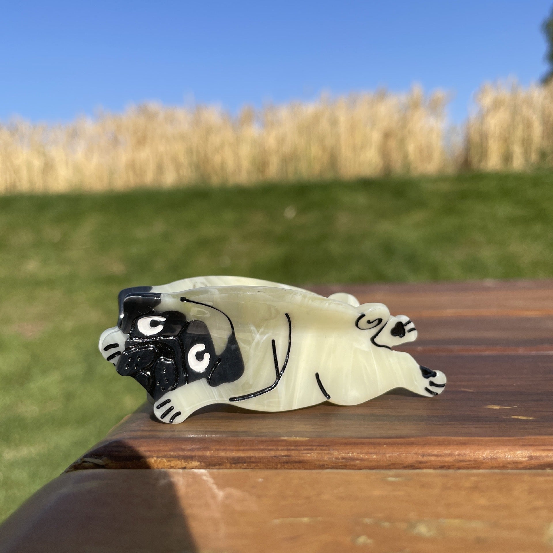 Hand-painted Pug design claw hair clip made from eco-friendly cellulose acetate.