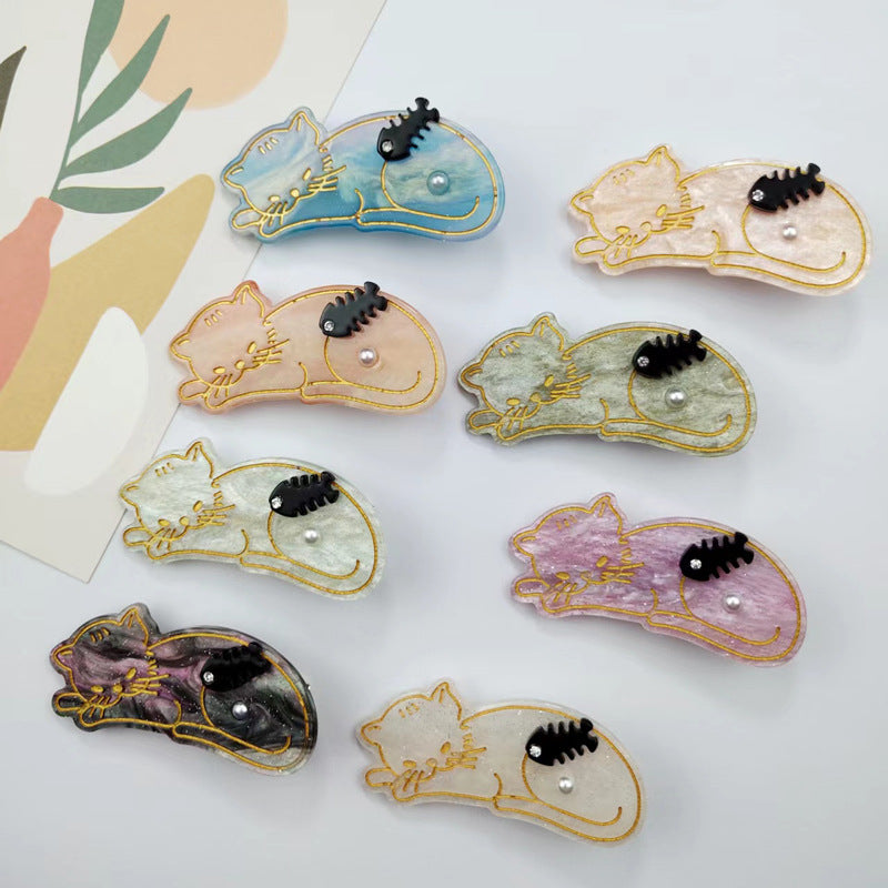 Hand-painted Sleeping Cat Hair Clip featuring rhinestones, made from eco-friendly cellulose acetate.