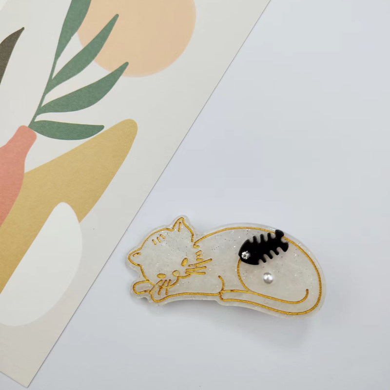 Hand-painted Sleeping Cat Hair Clip featuring rhinestones, made from eco-friendly cellulose acetate.