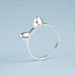 Adjustable sterling silver ring featuring cat ears and paw design, perfect for pet lovers.