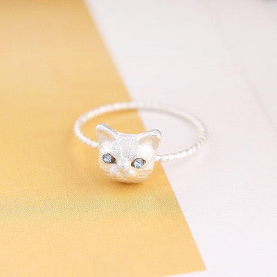 Adjustable sterling silver ring featuring cat ears and paw design, perfect for pet lovers.