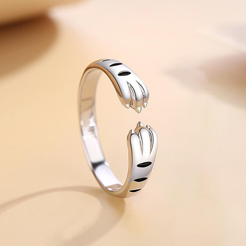 Adjustable sterling silver ring featuring cat ears and paw design, perfect for pet lovers.