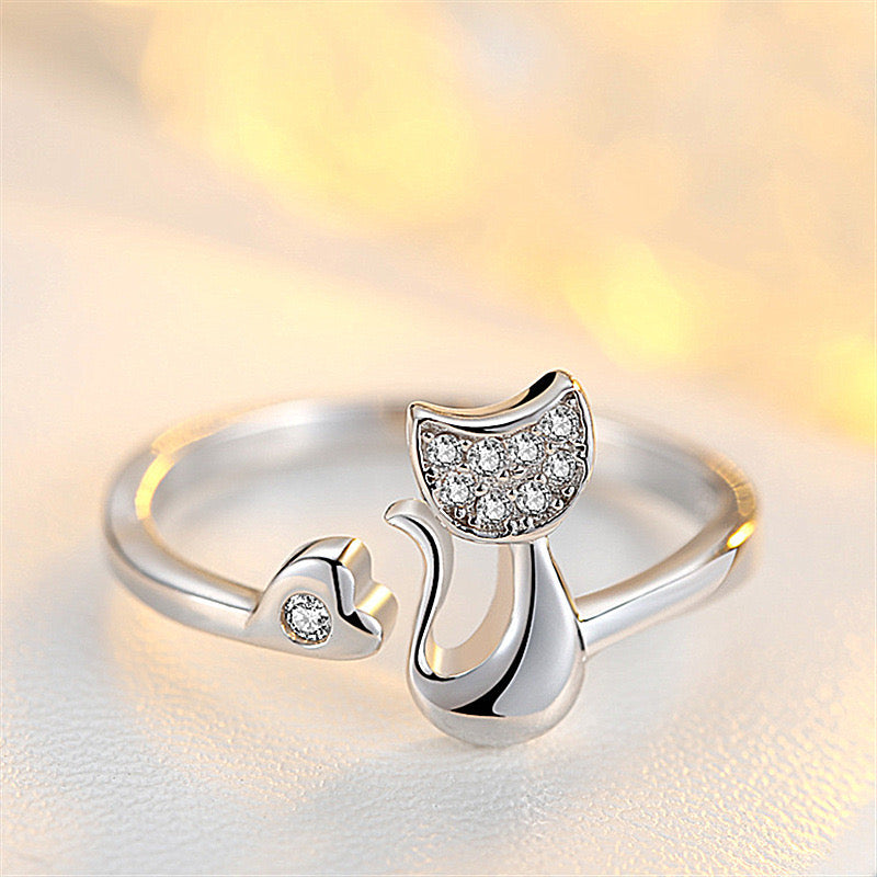 Adjustable sterling silver ring featuring cat ears and paw design, perfect for pet lovers.