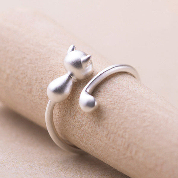 Adjustable sterling silver ring featuring cat ears and paw design, perfect for pet lovers.