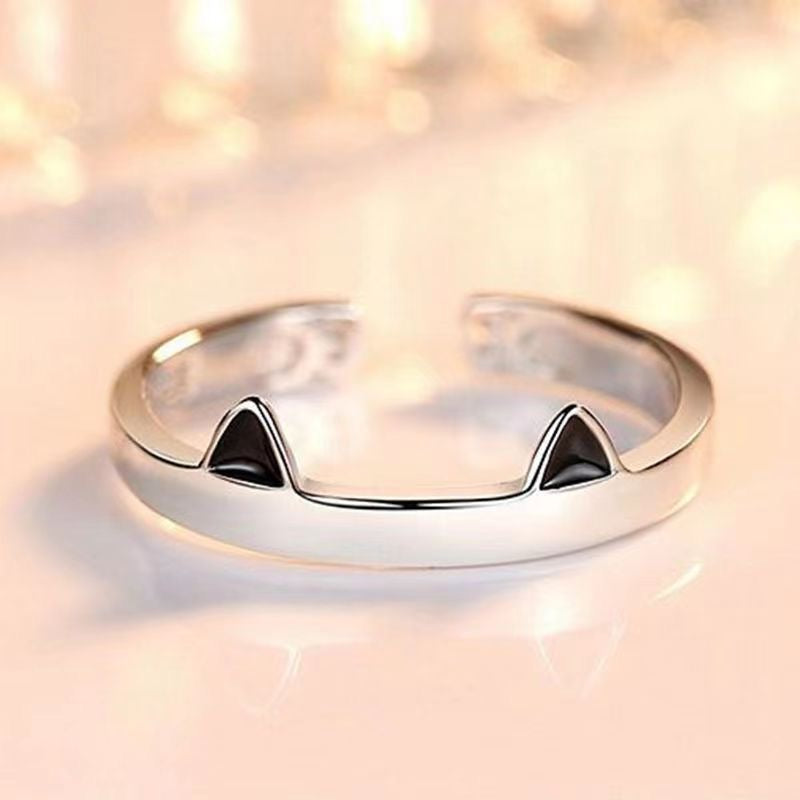 Adjustable sterling silver ring featuring cat ears and paws, perfect for pet lovers.