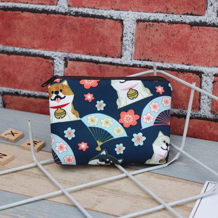 A stylish PAWSOME ZIPPER POUCH featuring various patterns, made from soft polyester microfiber, ideal for organizing essentials.