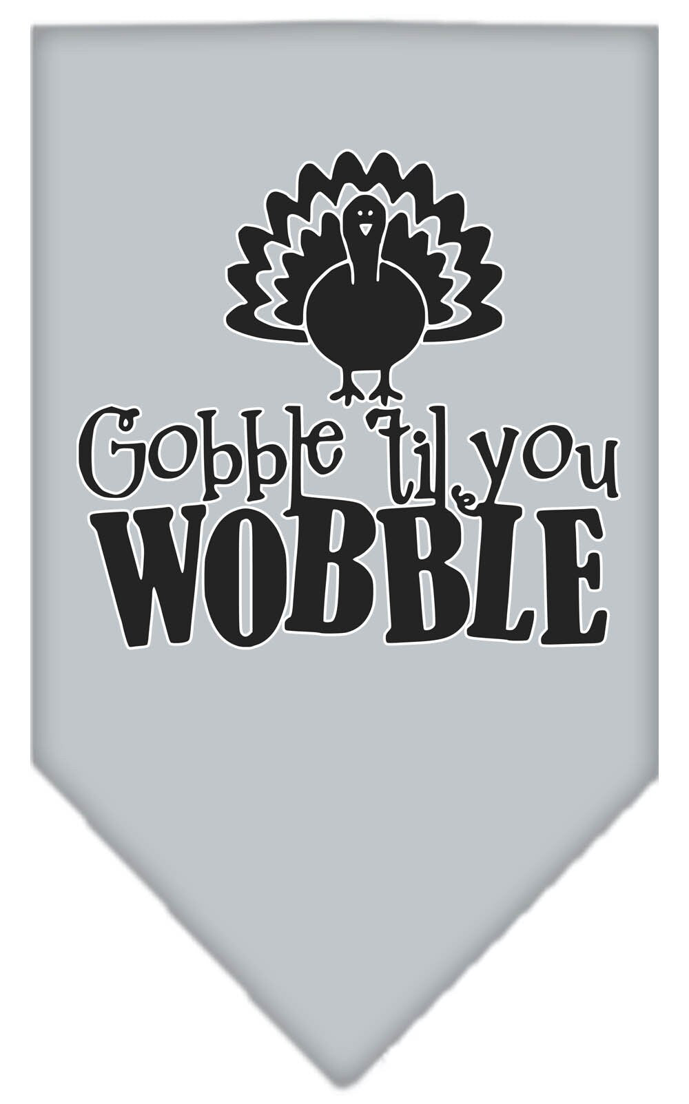 A stylish dog wearing a 'Gobble Til You Wobble' bandana, showcasing its festive design and tie-on style.