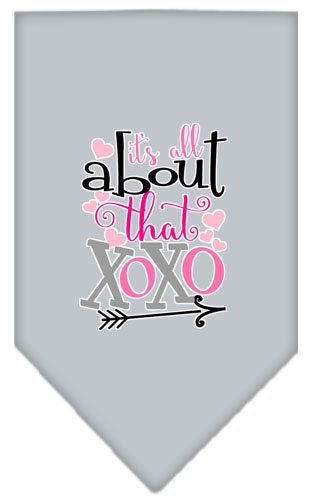 A stylish pet bandana featuring the phrase 'It's All About That XOXO', designed for dogs with a tie-on feature.