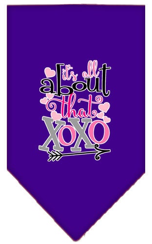 A stylish pet bandana featuring the phrase 'It's All About That XOXO', designed for dogs with a tie-on feature.