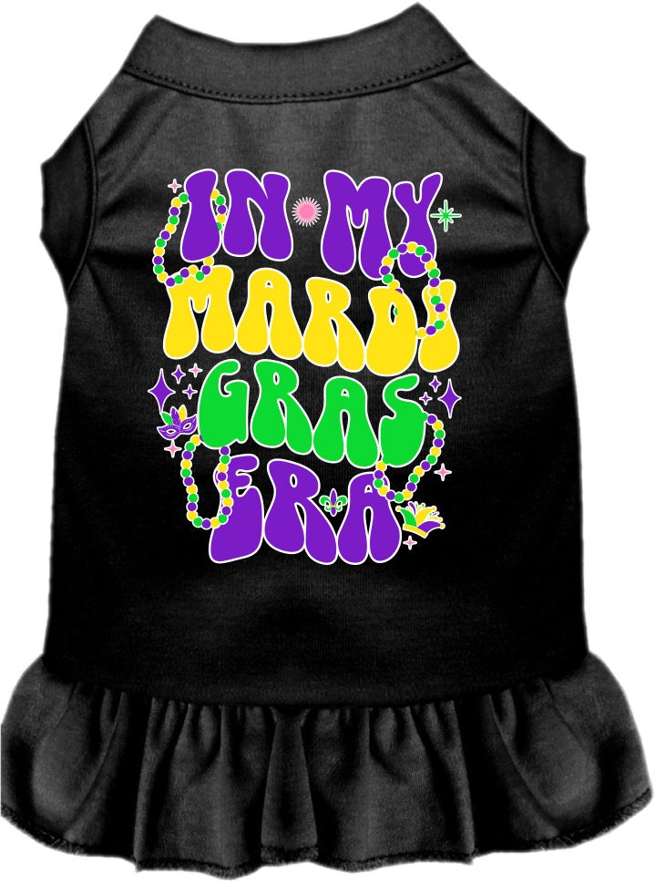 A medium to large pet wearing a colorful screen printed dress with ruffles, featuring a Mardi Gras theme.