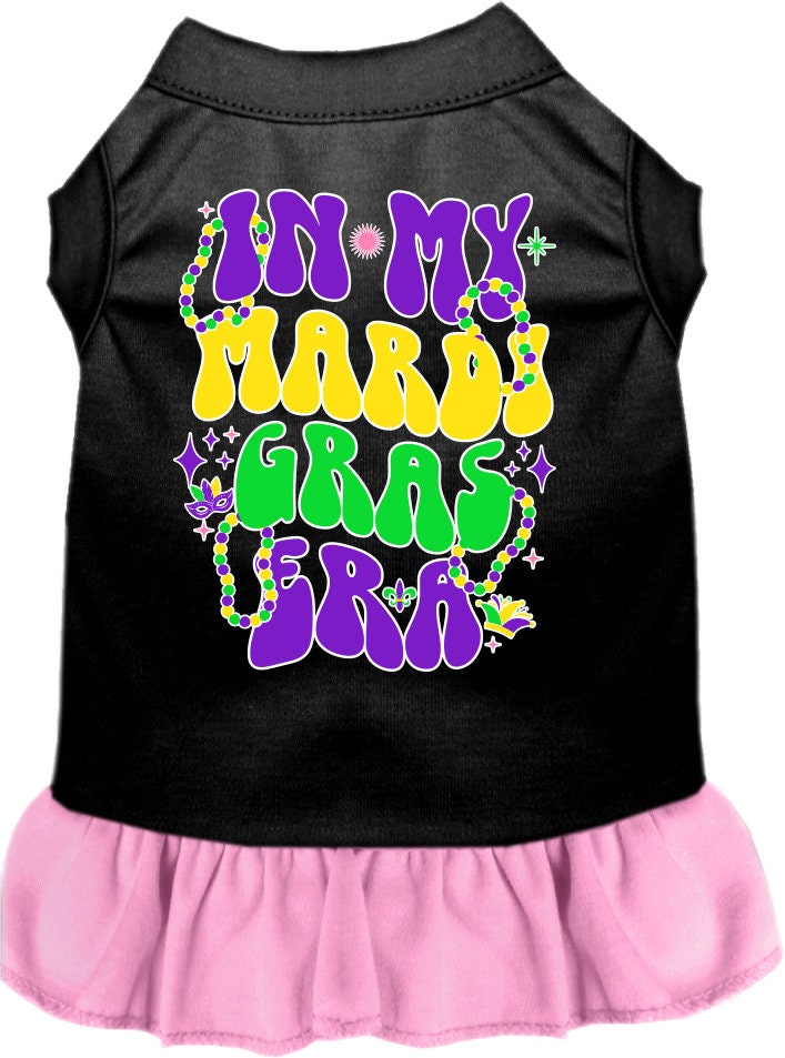 A medium to large pet wearing a colorful screen printed dress with ruffles, featuring a Mardi Gras theme.