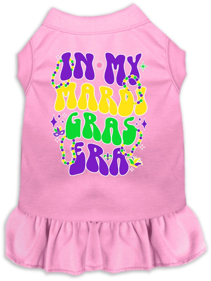 A medium to large pet wearing a colorful screen printed dress with ruffles, featuring a Mardi Gras theme.