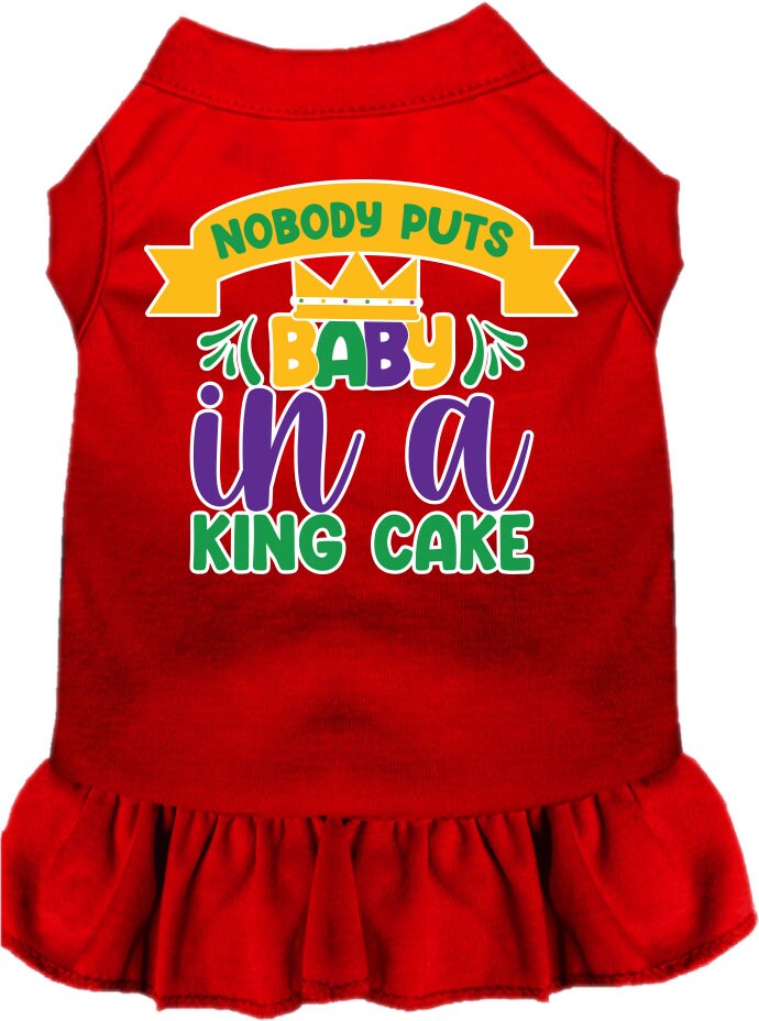 A medium to large pet wearing a stylish screen printed dress with ruffles, featuring the phrase 'Nobody Puts Baby In A King Cake'.