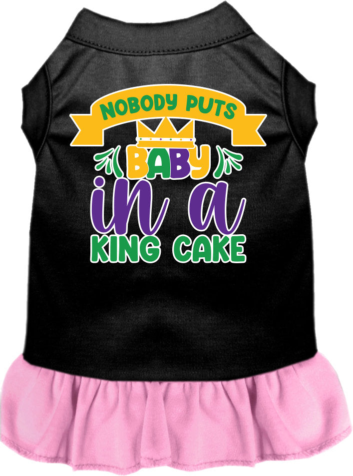 A medium to large pet wearing a stylish screen printed dress with ruffles, featuring the phrase 'Nobody Puts Baby In A King Cake'.
