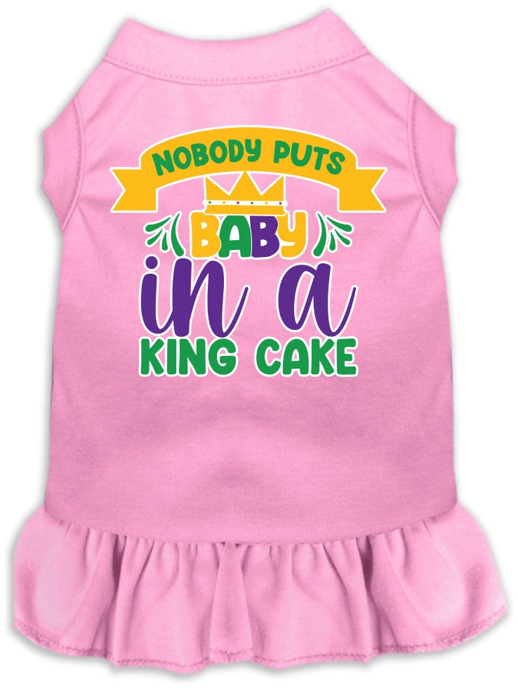 A medium to large pet wearing a stylish screen printed dress with ruffles, featuring the phrase 'Nobody Puts Baby In A King Cake'.