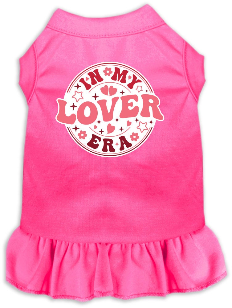 A small to medium pet wearing a stylish screen printed dress with ruffles, labeled 'In My Lover Era', showcasing comfort and cuteness.