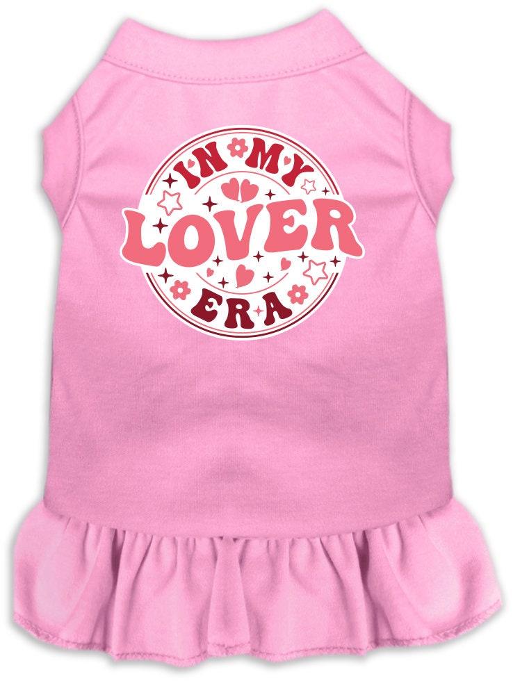 A small to medium pet wearing a stylish screen printed dress with ruffles, labeled 'In My Lover Era', showcasing comfort and cuteness.