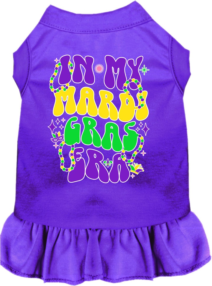 A small to medium pet wearing a colorful screen printed dress with ruffles, titled 'In My Mardi Gras Era', showcasing vibrant Mardi Gras colors.