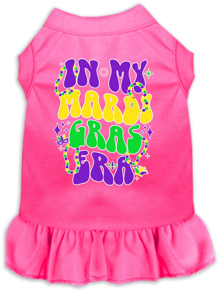 A small to medium pet wearing a colorful screen printed dress with ruffles, titled 'In My Mardi Gras Era', showcasing vibrant Mardi Gras colors.