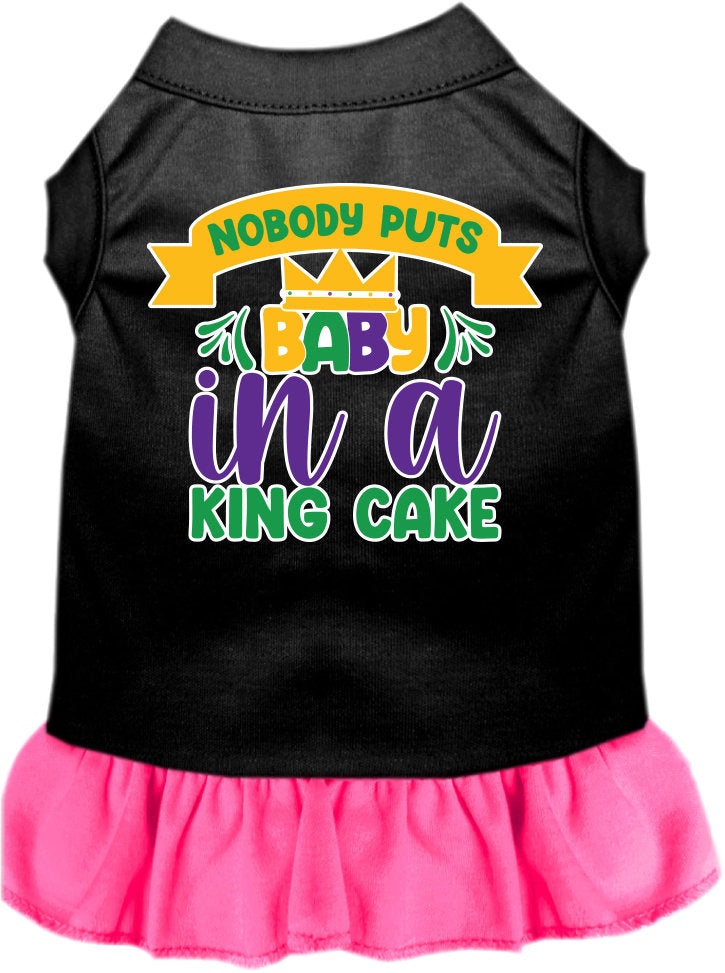 A cute screen printed dress for small to medium pets, featuring ruffles and the phrase 'Nobody Puts Baby In A King Cake'.